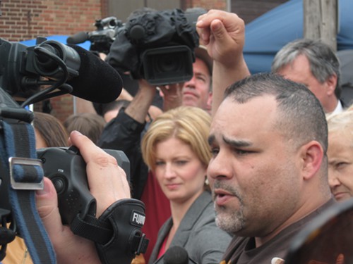 Lozada speaks to the crowd on Seymour Avenue.